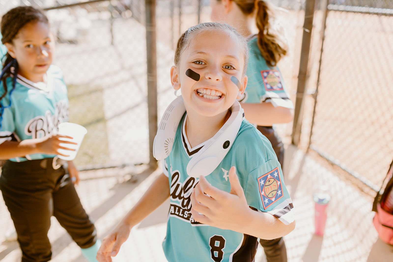 Bluffton All-Star player giving a thumbs-up in the dugout