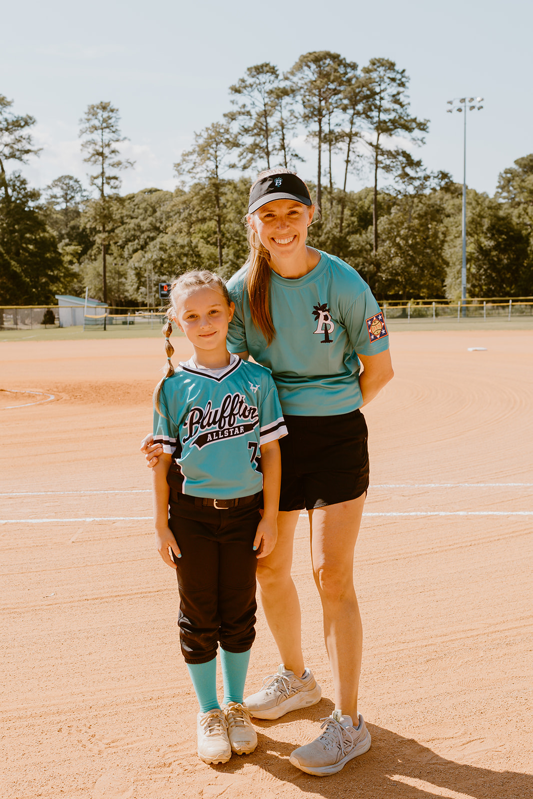 Bluffton All-Star player standing with her coach on the softball field