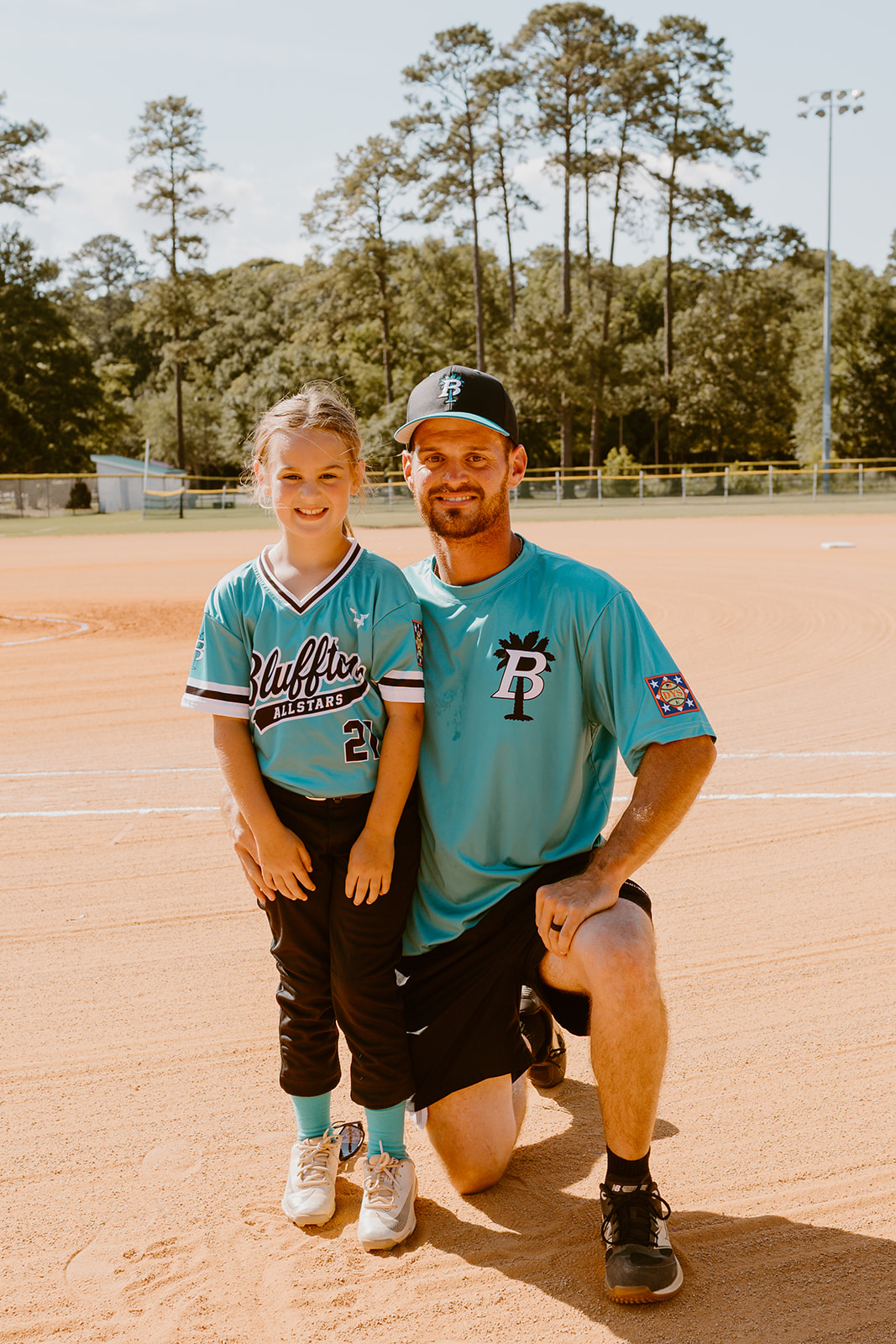Bluffton All-Star player posing with her coach on the infield