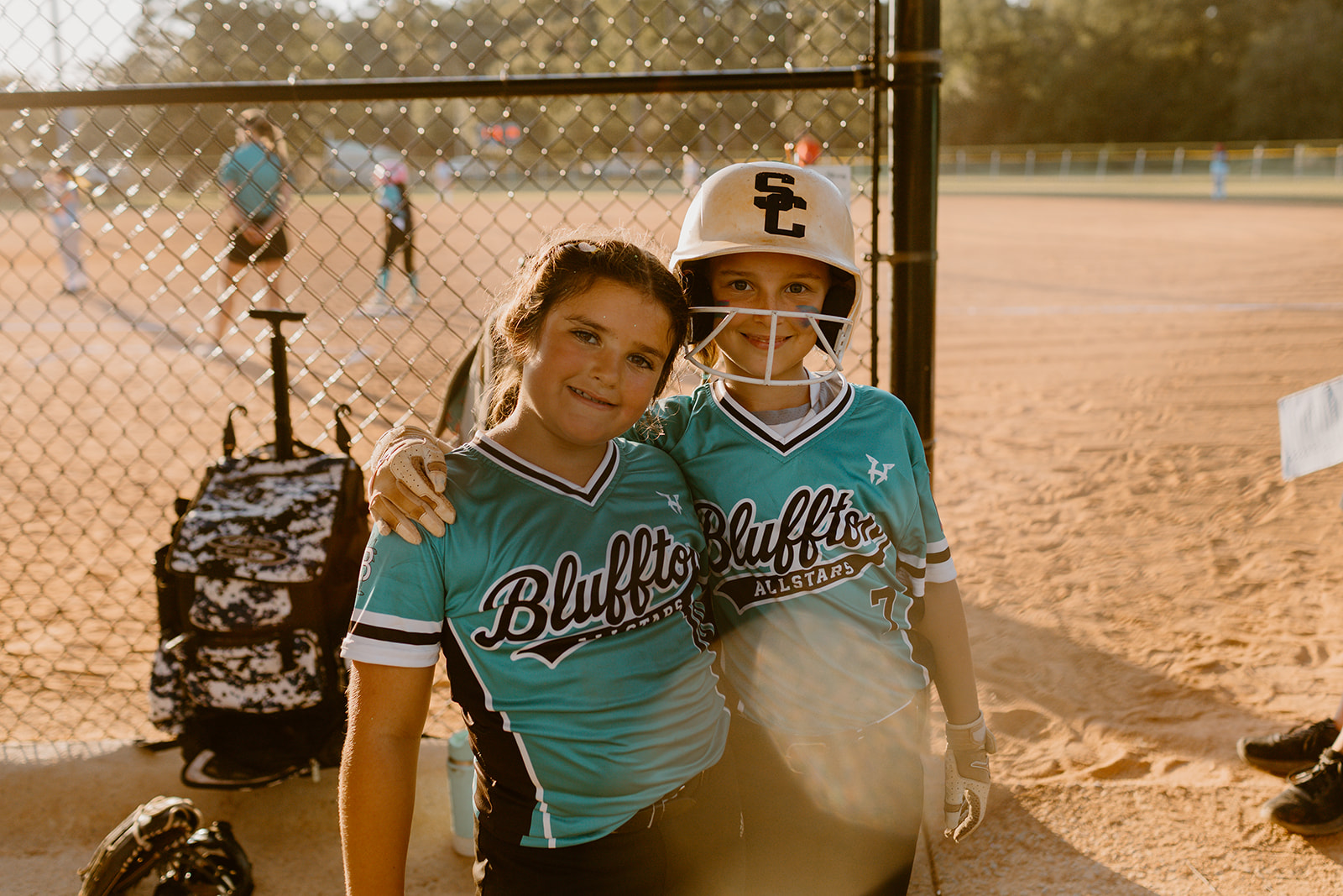 Two Bluffton All-Star teammates smiling together by the field