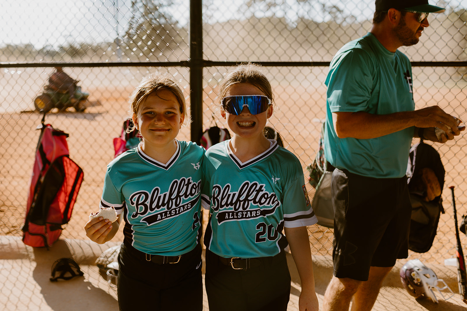 Two Bluffton All-Star players smiling in the dugout